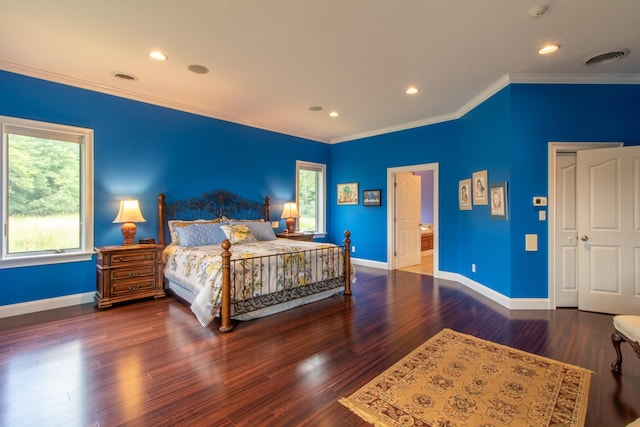 bedroom with crown molding and dark wood-type flooring