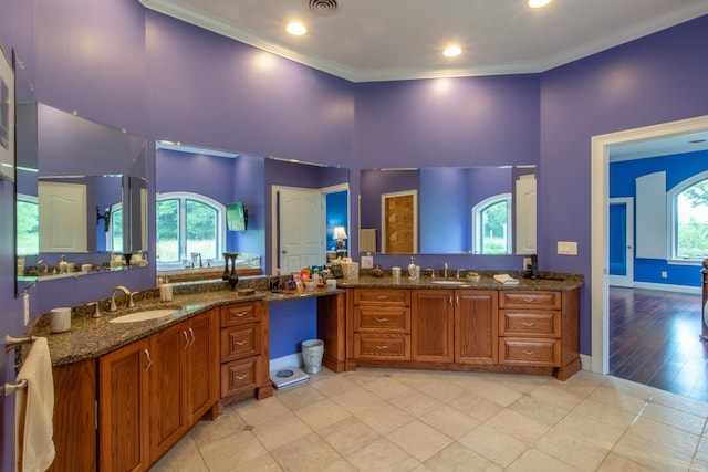 bathroom featuring ornamental molding, tile patterned flooring, and vanity