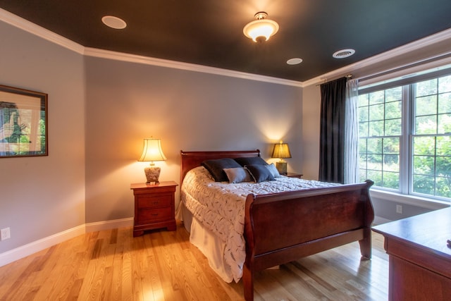 bedroom featuring light hardwood / wood-style flooring and ornamental molding