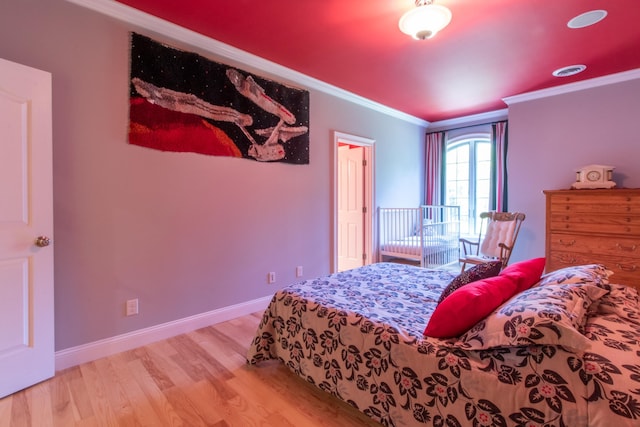 bedroom featuring wood-type flooring and ornamental molding