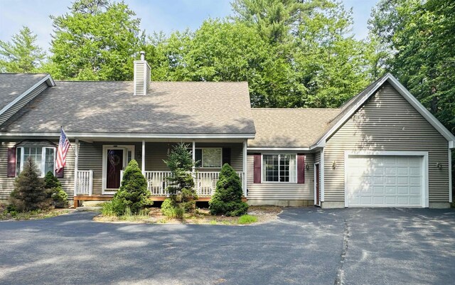 view of front of home featuring covered porch and a garage