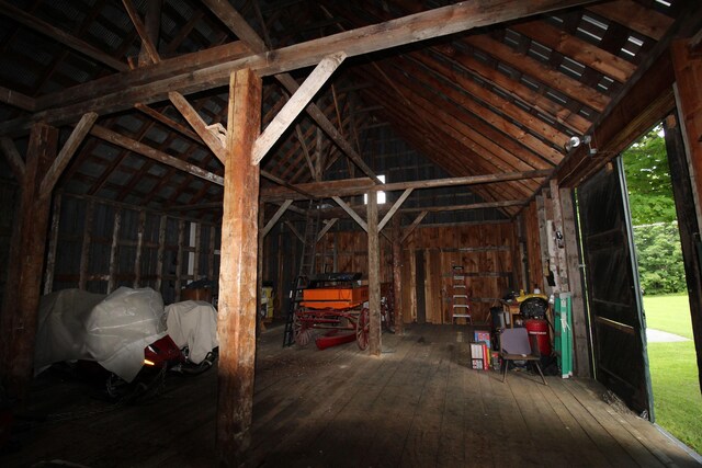 miscellaneous room featuring wood-type flooring and vaulted ceiling