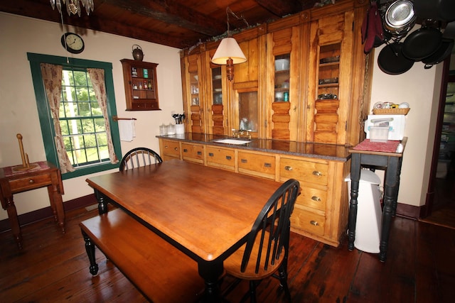 dining room featuring baseboards, beamed ceiling, dark wood-style floors, and wood ceiling