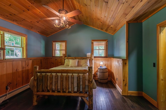 bedroom with a baseboard heating unit, wainscoting, and multiple windows