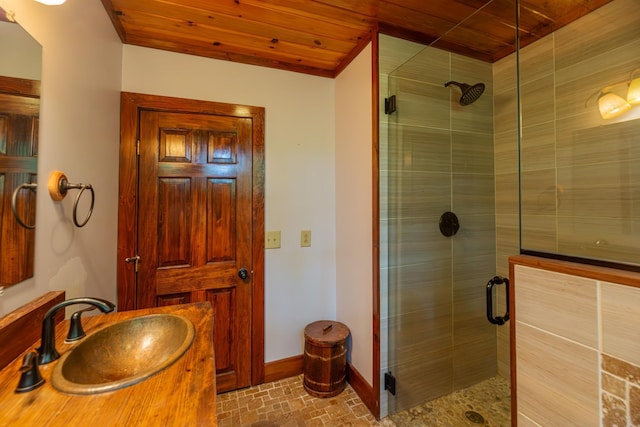 bathroom featuring a stall shower, wood ceiling, vanity, and baseboards