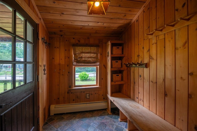 mudroom featuring plenty of natural light, wood walls, a baseboard radiator, and wooden ceiling