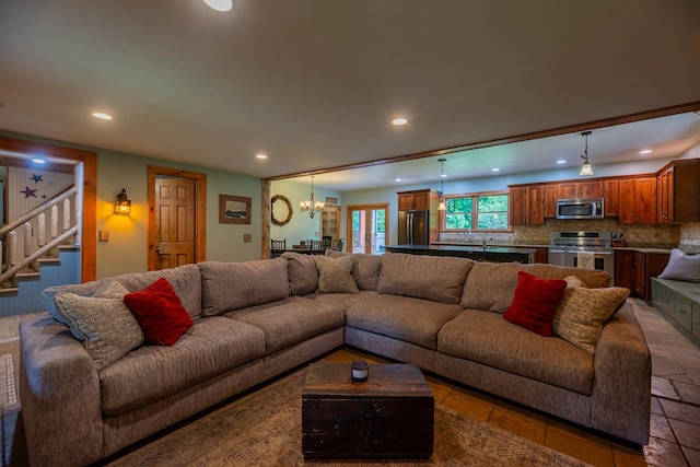 living room featuring stairway, a notable chandelier, and recessed lighting