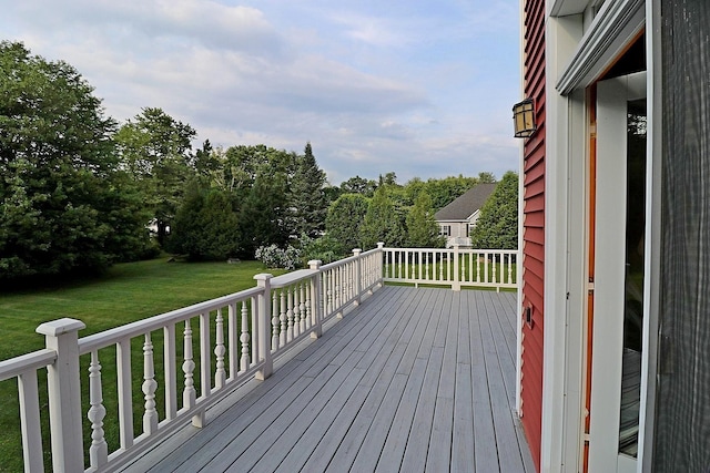 wooden deck featuring a yard