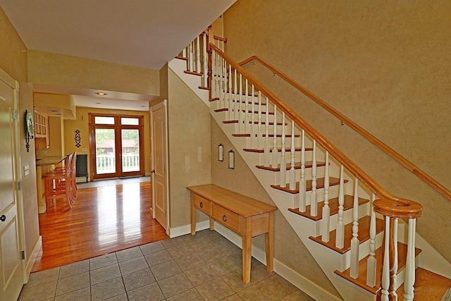 stairs featuring tile patterned floors