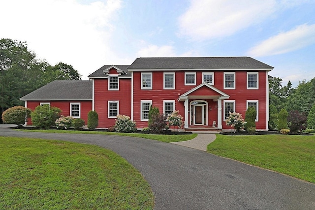 colonial home with a front yard