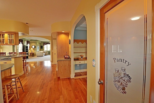 corridor with hardwood / wood-style floors