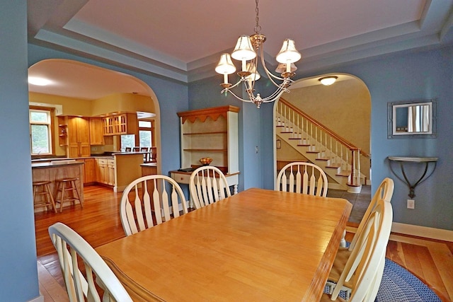 dining room with light hardwood / wood-style floors and a chandelier