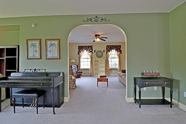 carpeted living room featuring ceiling fan