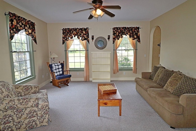 living room with carpet floors, a wealth of natural light, and ceiling fan