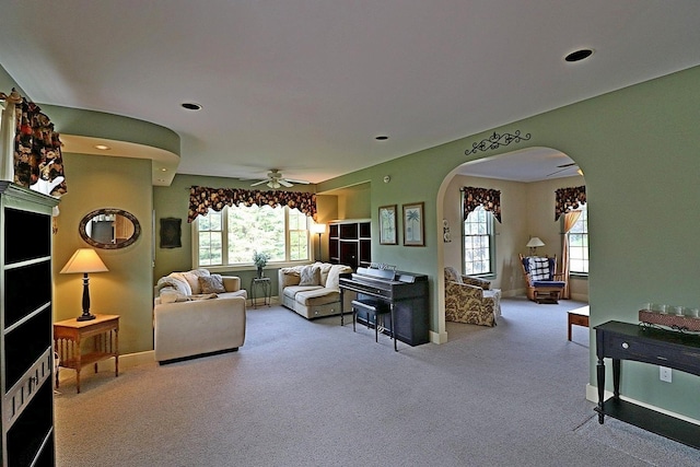 living room with light carpet, a wealth of natural light, and ceiling fan