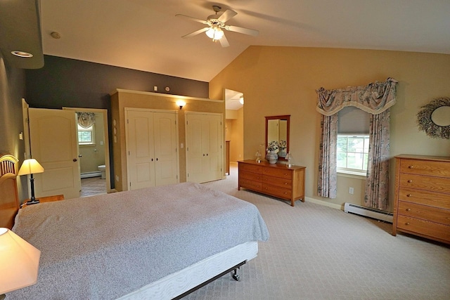 bedroom featuring ensuite bath, a baseboard radiator, light colored carpet, and vaulted ceiling