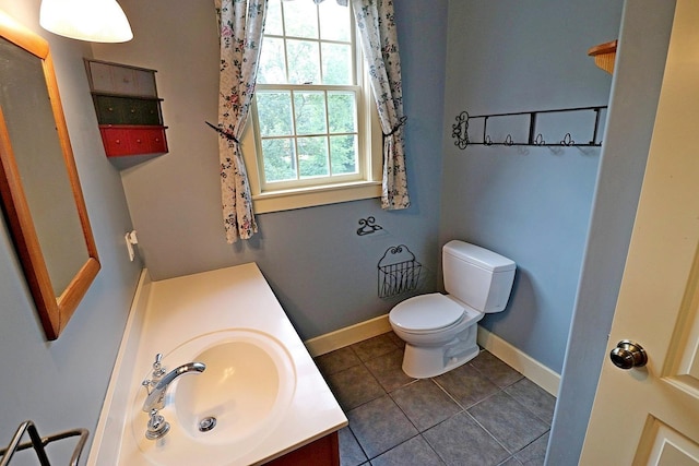 bathroom featuring vanity, tile patterned floors, and toilet