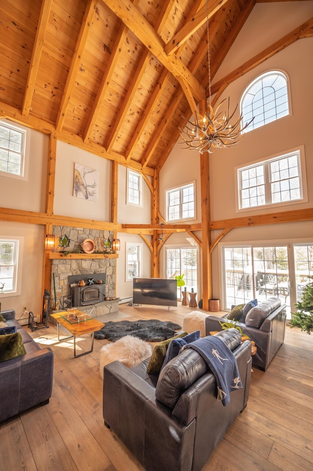 living room with beam ceiling, light hardwood / wood-style flooring, high vaulted ceiling, and wooden ceiling