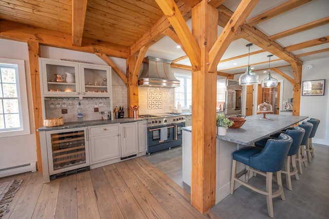 kitchen featuring white cabinetry, hanging light fixtures, premium appliances, custom range hood, and beverage cooler