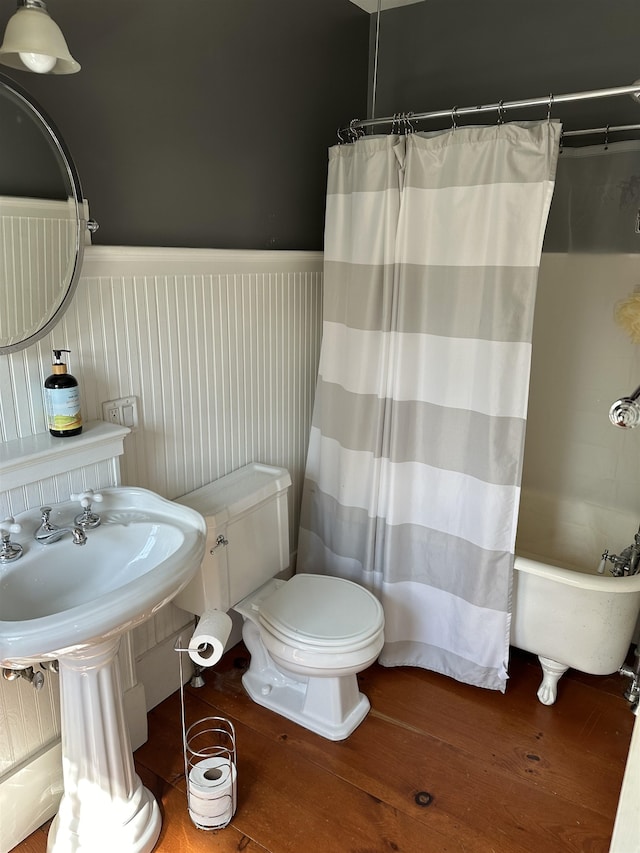 bathroom featuring separate shower and tub, hardwood / wood-style floors, and toilet