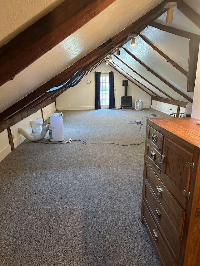 bonus room with vaulted ceiling with beams and carpet