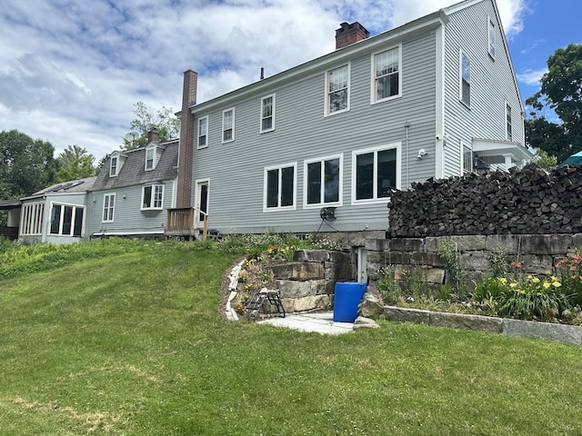 rear view of property featuring a yard