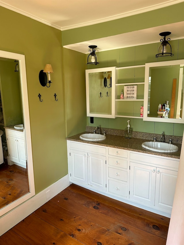 bathroom featuring crown molding, vanity, and hardwood / wood-style flooring