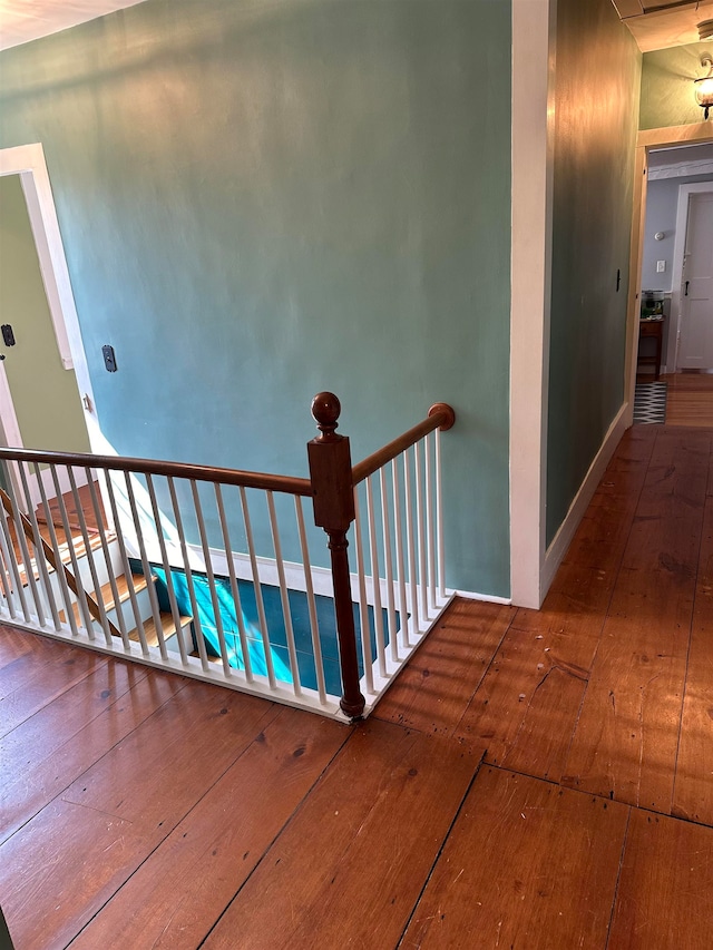 stairway with hardwood / wood-style flooring