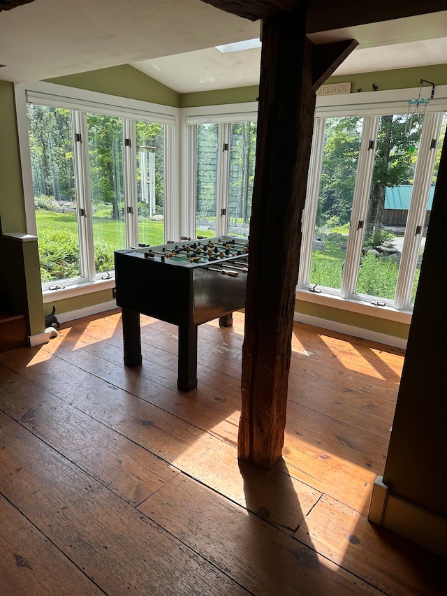 rec room featuring lofted ceiling, plenty of natural light, and light hardwood / wood-style floors