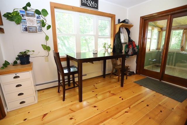 dining room featuring crown molding and light hardwood / wood-style floors