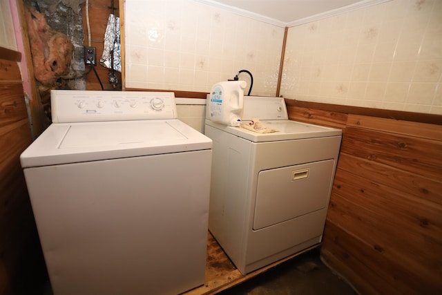 clothes washing area with independent washer and dryer and ornamental molding