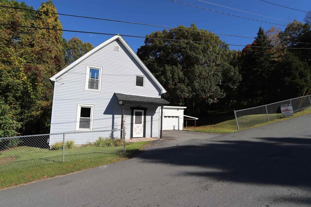 view of property exterior featuring a carport, a garage, and a lawn