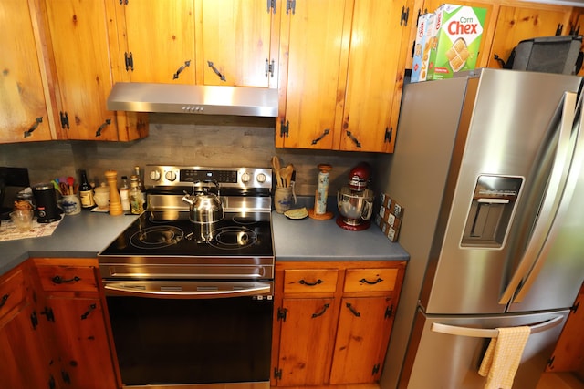 kitchen with appliances with stainless steel finishes and decorative backsplash