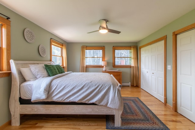 bedroom featuring a baseboard radiator, light wood-type flooring, and ceiling fan