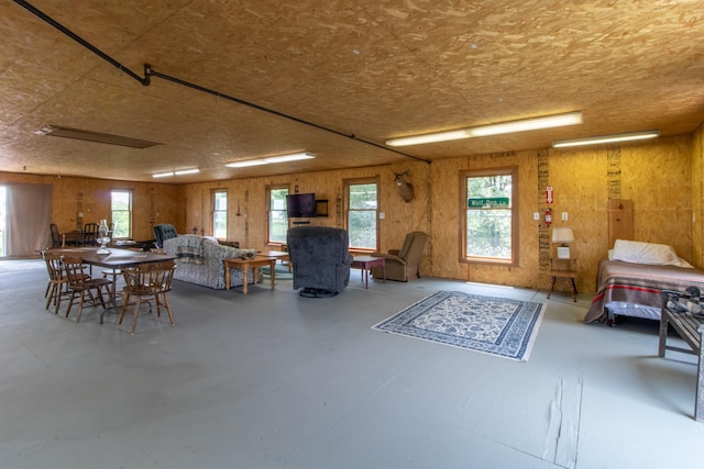 interior space featuring concrete flooring and wood walls