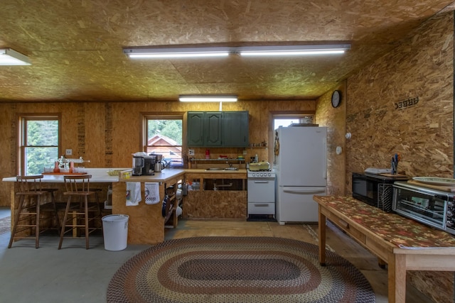 kitchen featuring sink, a wealth of natural light, and white appliances