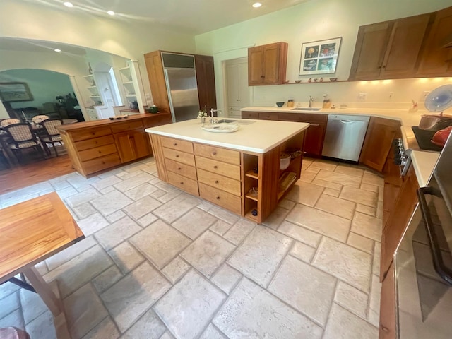 kitchen with a center island, stainless steel dishwasher, and sink