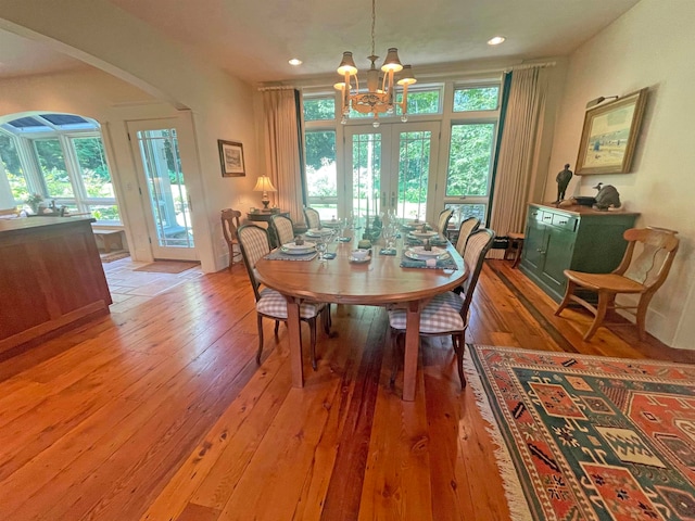 dining room featuring hardwood / wood-style flooring and an inviting chandelier