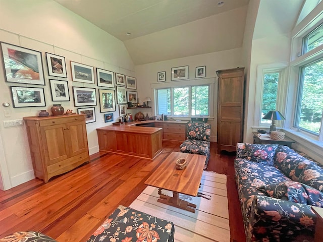 office area with light wood-type flooring and vaulted ceiling