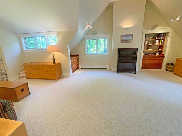 additional living space featuring light colored carpet, vaulted ceiling, and a baseboard heating unit