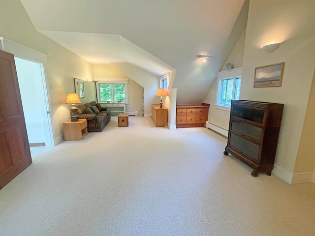 interior space with baseboard heating, light carpet, and vaulted ceiling