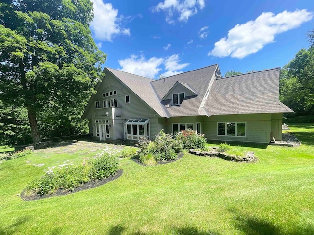 rear view of house with a yard