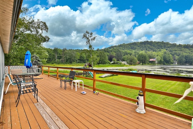 wooden deck featuring a yard