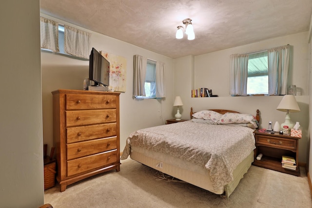 bedroom featuring light carpet