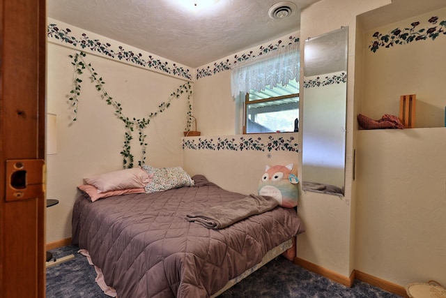 carpeted bedroom with a textured ceiling