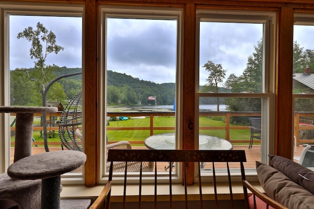 sunroom / solarium featuring a water view