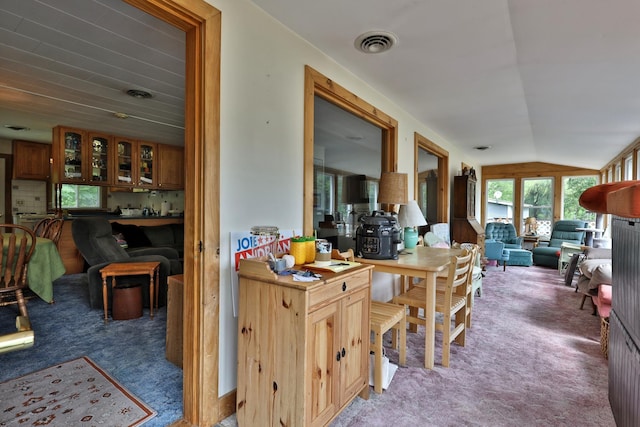 kitchen with vaulted ceiling and carpet flooring