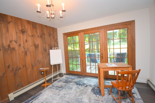 dining space with an inviting chandelier, a baseboard radiator, dark hardwood / wood-style floors, and a wealth of natural light