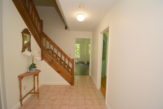 carpeted bedroom with a baseboard radiator and vaulted ceiling