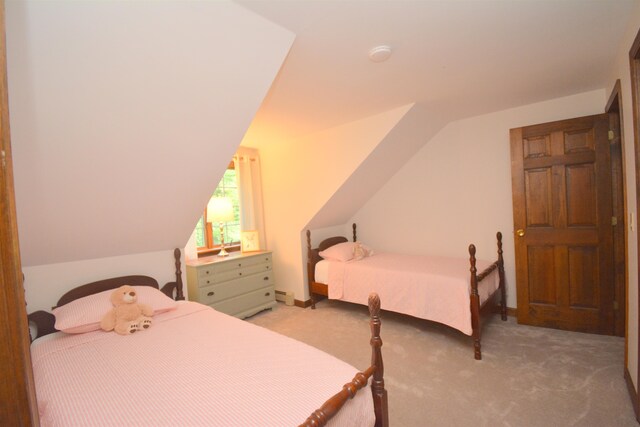 bedroom featuring carpet and vaulted ceiling